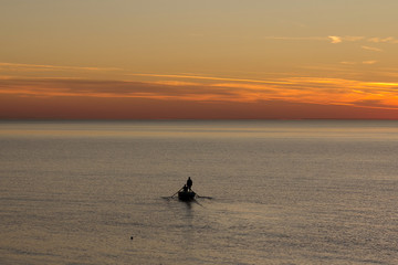 Fototapeta premium Silhouette of the man in a boat