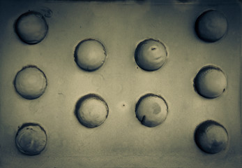 Old rusty rivets on large corroding steel plates of a train and