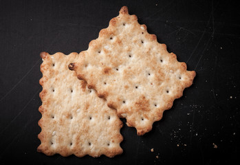 cookies crackers and crumbs on a dark background