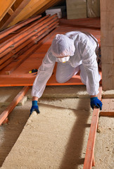 Man laying thermal insulation layer - wearing protective clothin