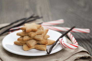 holiday cookies and candy canes on wood table