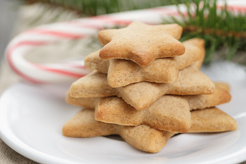 star cookies and candy cane on table