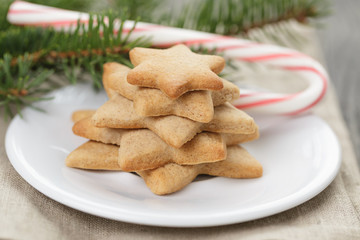 star cookies and candy cane on table