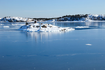 Small islands in the sea in winter scenery. Nynashamn, Sweden.