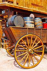 Fototapeta na wymiar Old cart with wine barrels.Wild West.