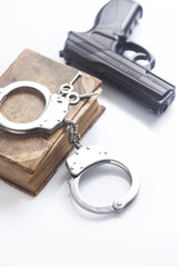 handcuffs and book on law and gun