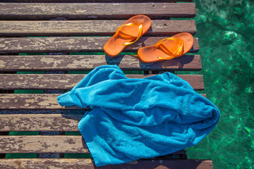 flip-flops and towel on the jetty