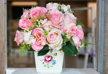 fake pink rose bouquet in white vase