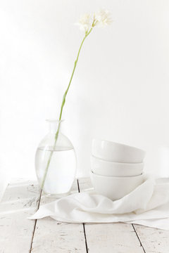 total white table with stem tuberose flower on glass and bowls