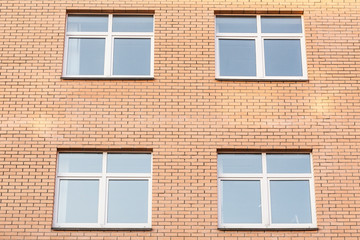 Fototapeta na wymiar Square windows in brick wall of a house