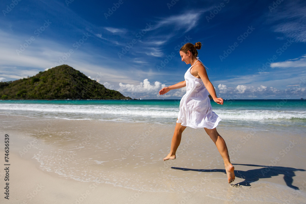 Wall mural Caucasian woman rests at beautiful seashore