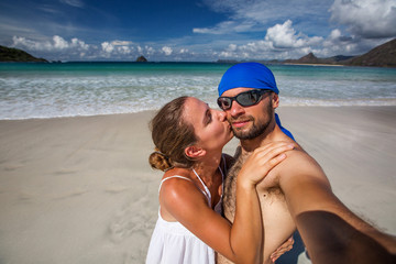 Man and woman have fun at the beach of island in Indian ocean