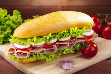 big sandwich with ham, cheese and vegetables