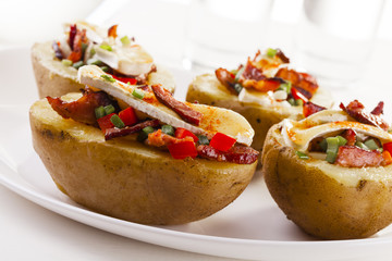 Baked potatoes stuffed with bacon, served with camembert