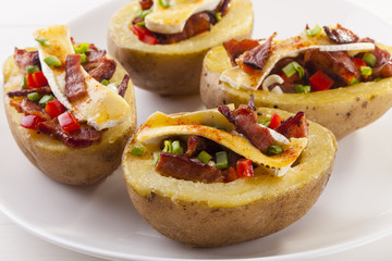 Baked potatoes stuffed with bacon, served with camembert