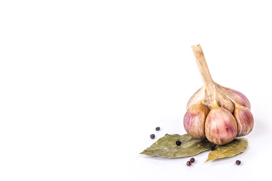 garlic on a bay leaf isolated on a white background