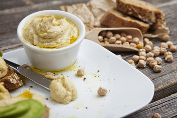 The composition of hummus on a wooden table
