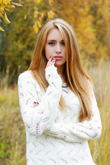 Portrait of the girl against an autumn trees