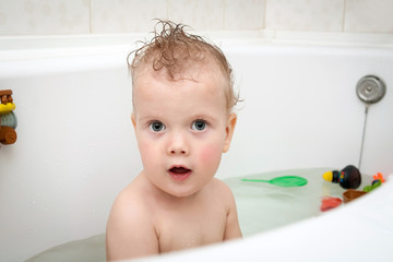 Portrait of cute baby in bath