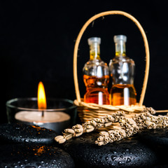 Obraz na płótnie Canvas Aromatic spa concept of bottles essential oil in basket, dried l
