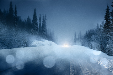 Fototapeta premium Car lights in winter forest