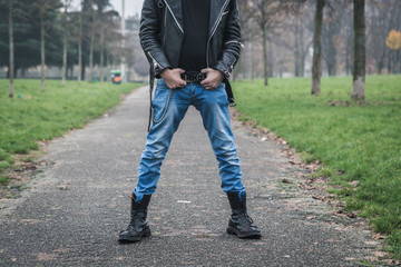 Punk guy posing in a city park