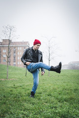 Punk guy posing in a city park