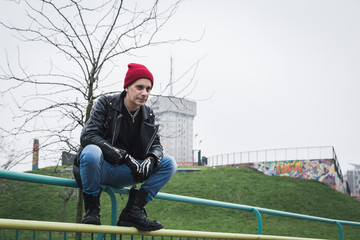 Punk guy posing in a city park