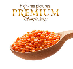 Red-orange lentil in a wooden spoon  on white background