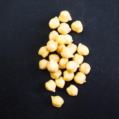 Golden  Chick-pea cereal  over black  chalk board  table close