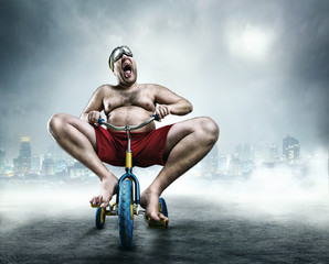 Nerdy man riding a small bicycle