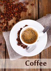 Cup of coffee with milk and coffee beans