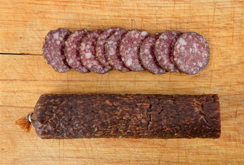 salami sliced on wooden board
