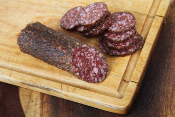 salami sliced on wooden board