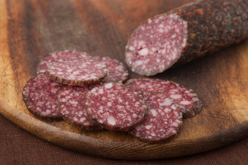 salami sliced on wooden board