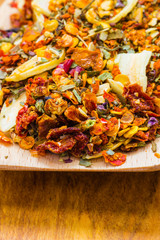 Colored spices for pasta mix on wooden spoon