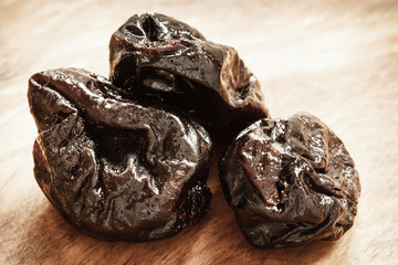 dried plums prunes on wooden table