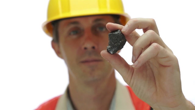 Miner Inspects Carbon Graphite Ore