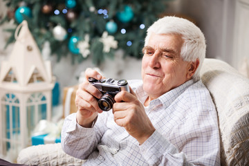 Senior man looking at camera on Christmas background