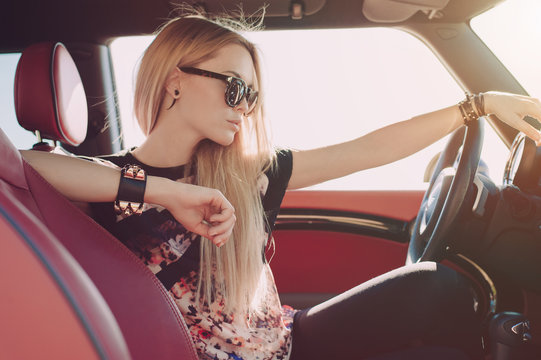 Blondie young girl at the wheel of sport car