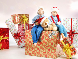 Two little brothers among presents