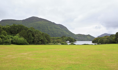 Fototapeta na wymiar Green lawn in front of Muckross Lake.