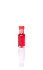 Liquid light red food color additive over white background