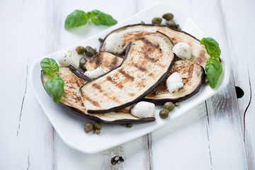Grilled aubergine slices with capers, mozzarella and basil