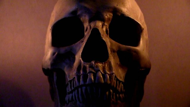 Human skull in flickering candle light