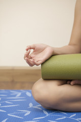 Young woman holding a yoga mat