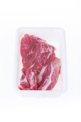 raw pork in plastic box package isolated on white background