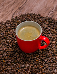 Cup of coffee and spilled coffee beans
