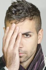 Fototapeta premium Young man coverin eye