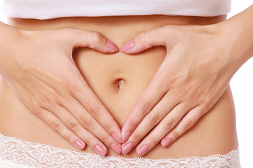 Hands on a female belly, isolated on white